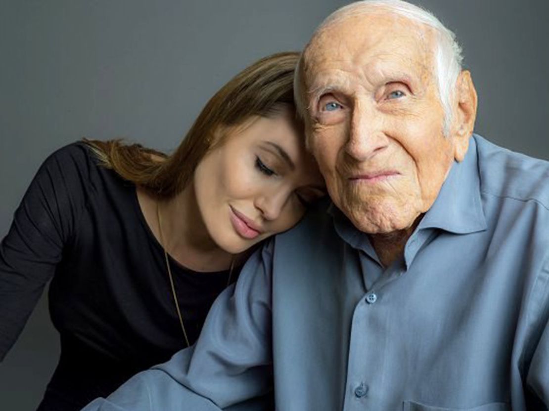 Louis Zamperini with "Unbroken" director  Angelina Jolie in October. The film, based on the bestseller about his life, comes to theaters this Christmas.