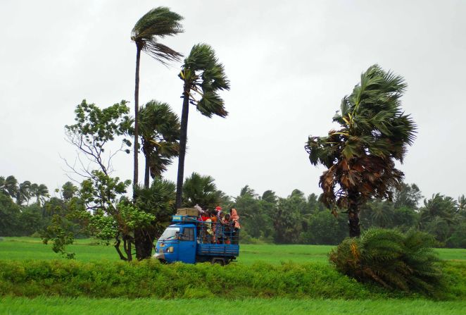 Evacuees leave the village of Sanabandha, India, on October 12.