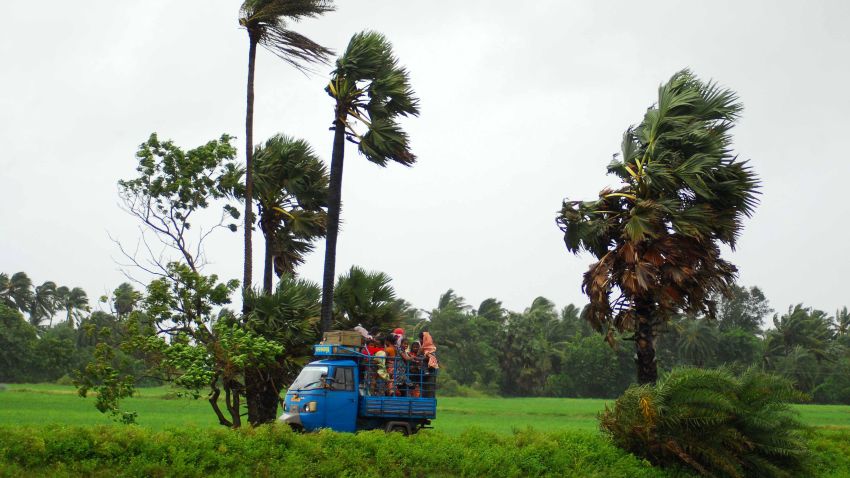 Indian evacuees travel in an auto rickshaw as they leave their village towards a safe place through heavy wind and rain in Sanabandha Village near Gopalpur, about 195 south from eastern city Bhubaneswar on October 12, 2013.   Nearly half a million people have been evacuated from India's impoverished east coast ahead of a massive cyclone expected to make landfall on October 12 evening, disaster officials said.  AFP PHOTO/ASIT KUMAR        (Photo credit should read ASIT KUMAR/AFP/Getty Images)