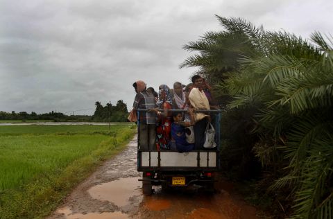 A small truck takes villagers to a cyclone shelter in Podampeta on October 12. 