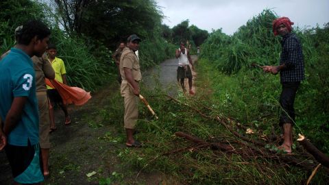 Volunteers clear branches off the road in the village of Badabandha on October 12.
