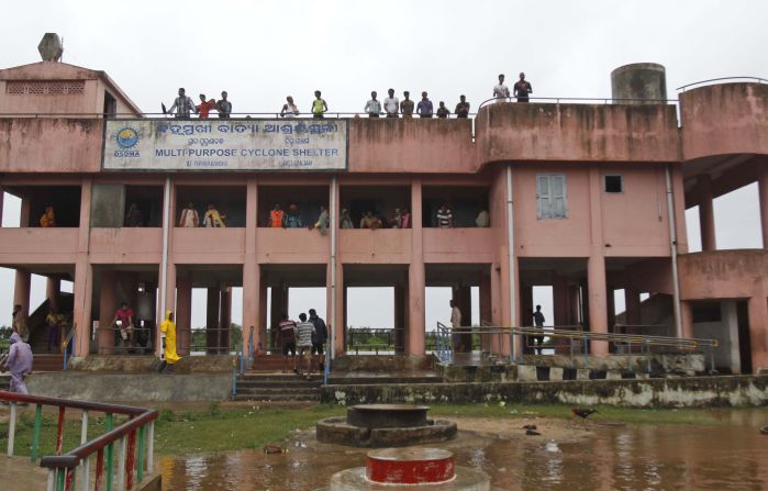 Villagers take refuge in a cyclone shelter in the village of Gokhorkuda, India, on October 12.