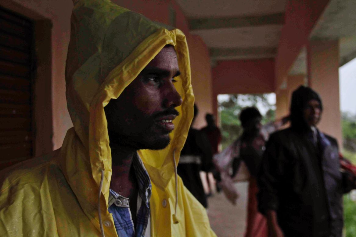 An man takes shelter at a school near Berhampur on October 12.