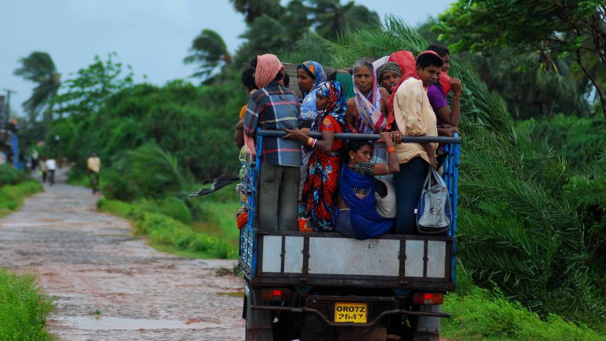 Indian evacuees travel in an auto rickshaw as they leave their village towards a safe place through heavy wind and rain in Sanabandha Village near Gopalpur, about 195 south from eastern city Bhubaneswar on October 12, 2013. Nearly half a million people have been evacuated from India's impoverished east coast ahead of a massive cyclone expected to make landfall on October 12 evening, disaster officials said.