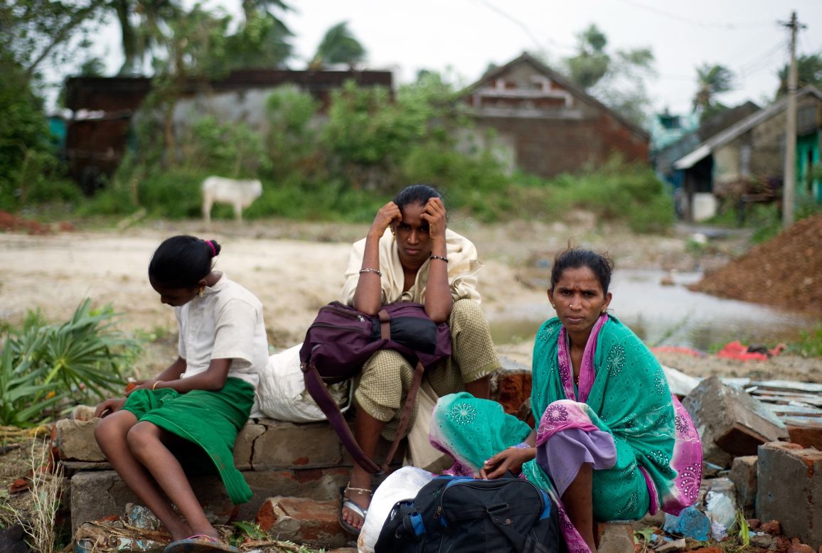 A displaced family waits at the village of Sonupur, India, on October 13.