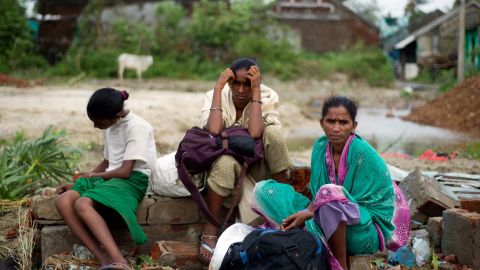 A displaced family waits at the village of Sonupur, India, on October 13.