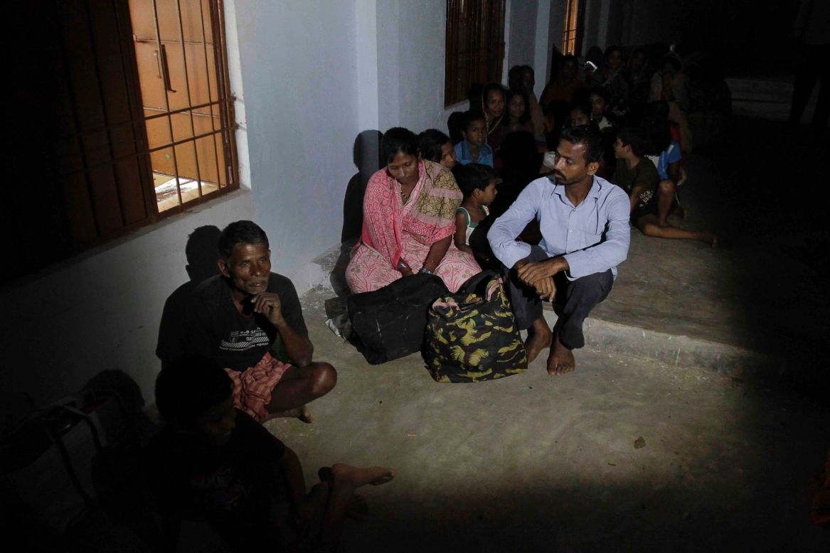 Evacuated villagers take shelter in a school building following the cyclone warning in Berhampur on Saturday, October 12.