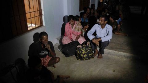 Evacuated villagers take shelter in a school building following the cyclone warning in Berhampur on Saturday, October 12.