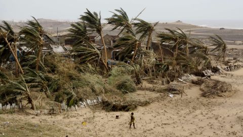 A woman returns to the village of Arjipalli on India's Bay of Bengal coast on October 13.