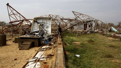 A man walks toward a damaged cellular phone tower in Berhampur on India's Bay of Bengal coast on October 13.