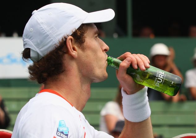 2013 Wimbledon champion Andy Murray jokingly drinks a bottle of beer given to him by at an exhibition in Australia, but like other star players he has cut out alcohol altogether.