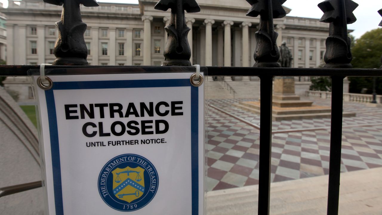 A closed sign hangs at the entrance to the U.S. Treasury building October 3.