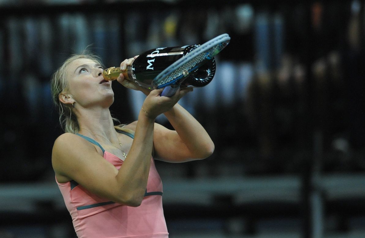 Maria Sharapova enjoys the traditional champagne offering to winners at a tournament in 2012.   