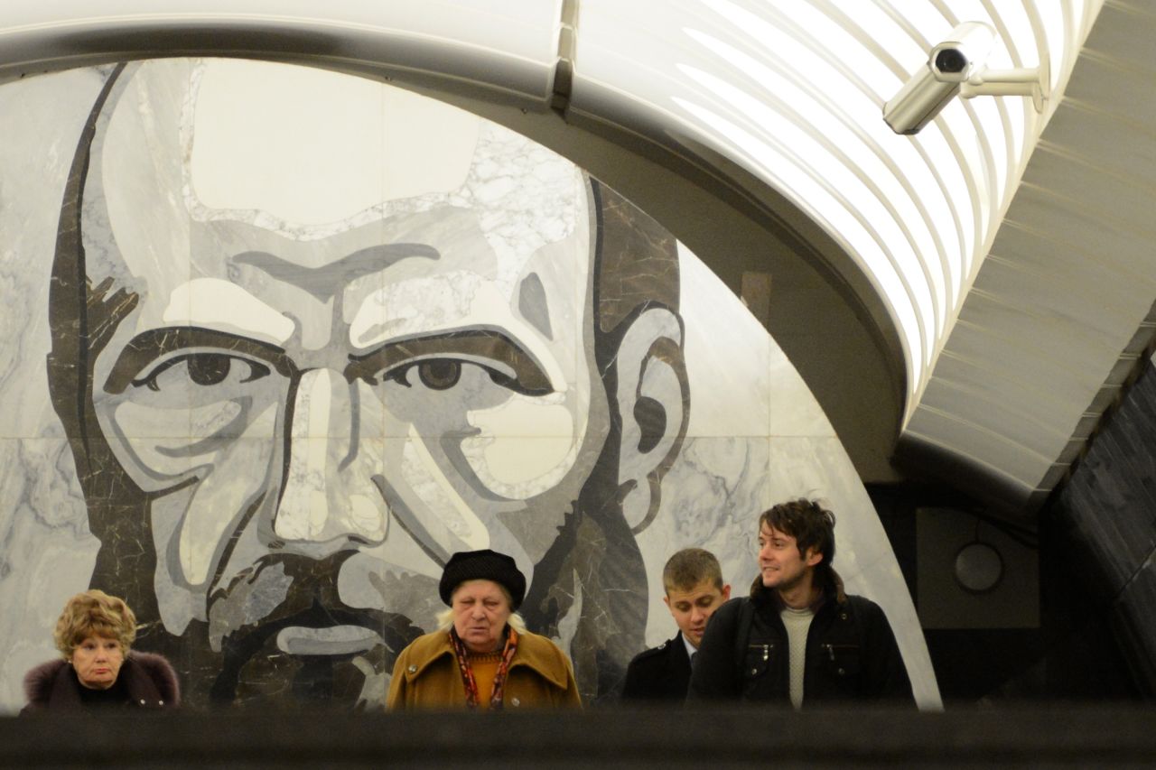 Passengers wait at the Dostoyevskaya metro station in Moscow. Much of the Russian capital's vast underground system is decorated with elaborate Soviet artwork. Here, a portrait of iconic author, Fyodor Dostoyevsky, looks down upon travelers.
