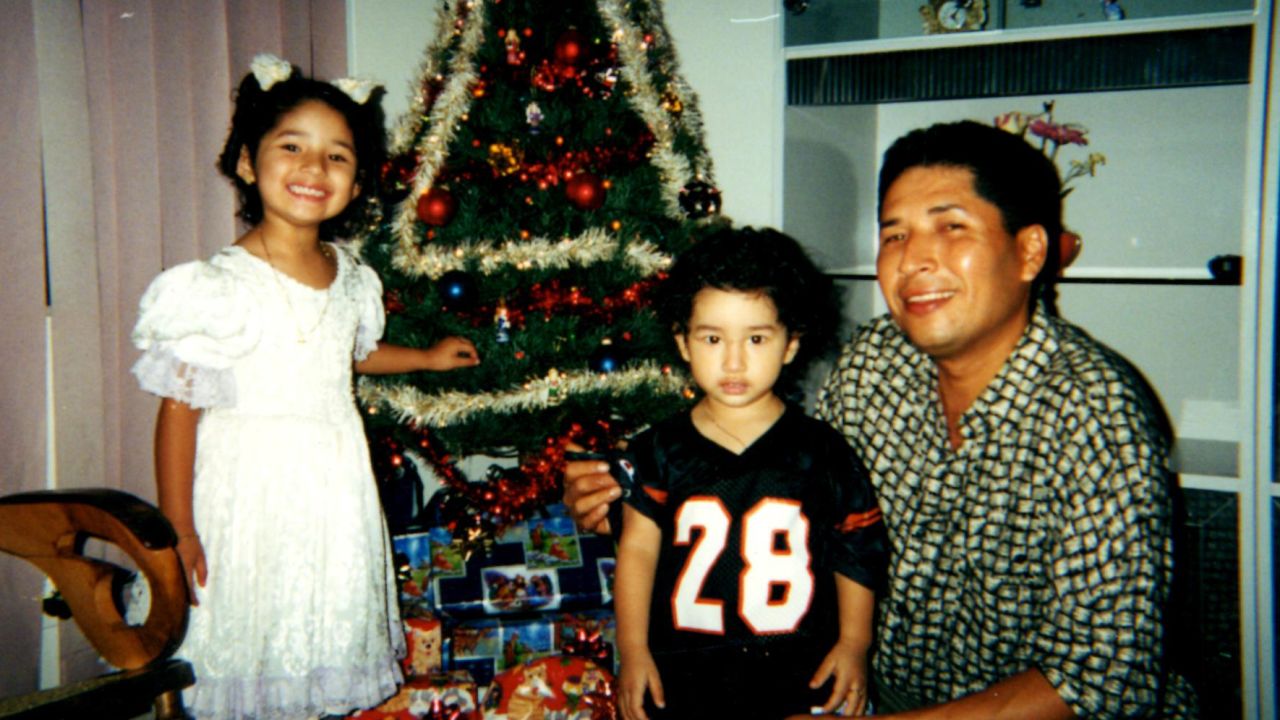 Ronald Soza and his children pose in a family Christmas photo.