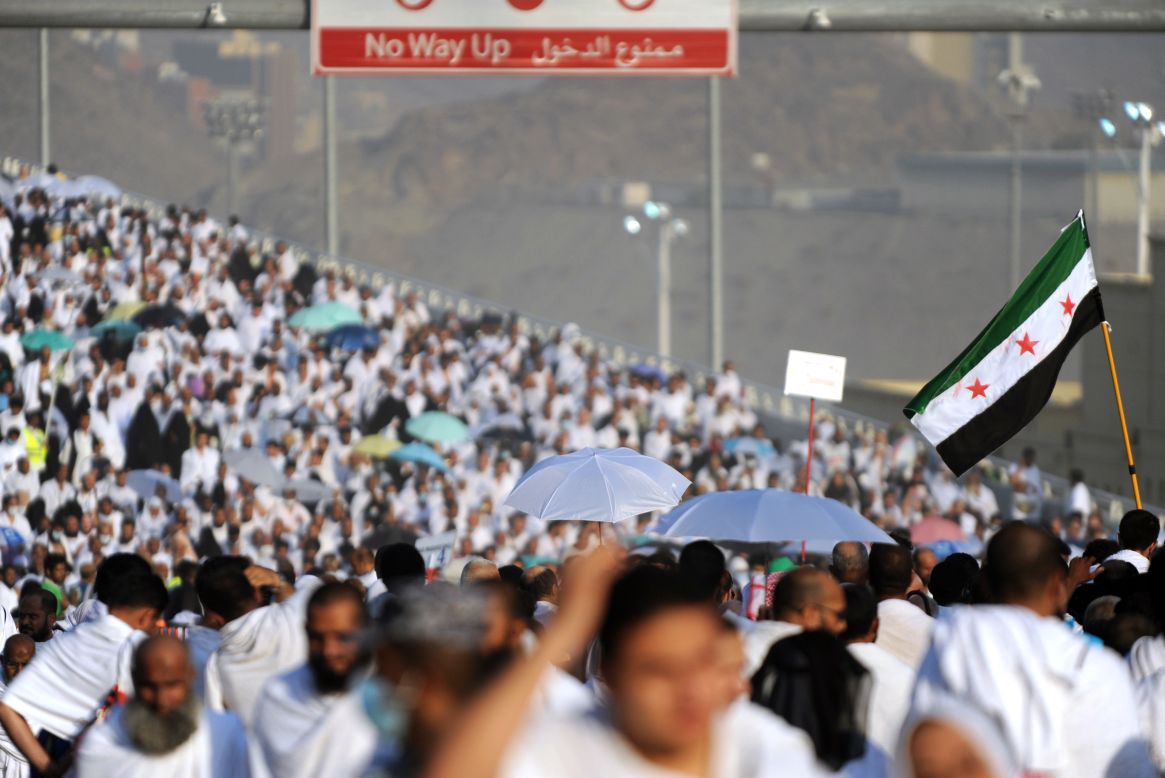 A Syrian revolution flag waves over Muslim pilgrims on their way to throw pebbles at pillars during the "Jamarat" ritual, or the stoning of Satan, on October 15 in Mina, Saudi Arabia, near the holy city of Mecca.