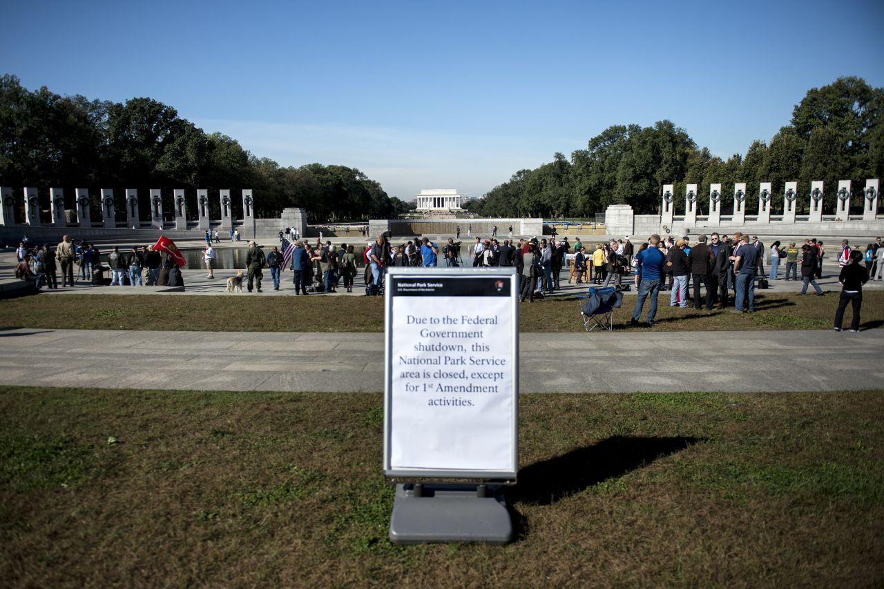 Visitors walk at the National World War II Memorial after a rally at the monument in Washington on Tuesday, October 15. Activists from veterans groups gathered to protest the partial shutdown of the U.S. government and to rally for resolutions to the budget crisis. Signs of the shutdown can be found across the country.