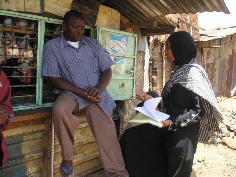 His organization "Pambazuko Mashinani" has a variety of social change programs in reproductive health, women's empowerment and youth outreach. Pictured, one of the group's volunteers conducts a field interview surveying people about tuberculosis. 