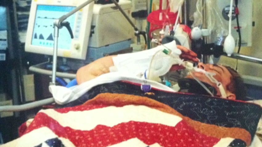 pkg soldier gives purple heart salute from hospital bed_00005307.jpg