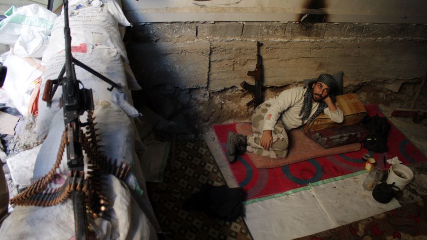 An opposition fighter rests on the front line in Syria's northeastern city of Deir Ezzor on Tuesday, October 15. More than 100,000 people reportedly have been killed in Syria since a popular uprising spiraled into a civil war in 2011. Click through to view the most compelling images taken since the start of the conflict: