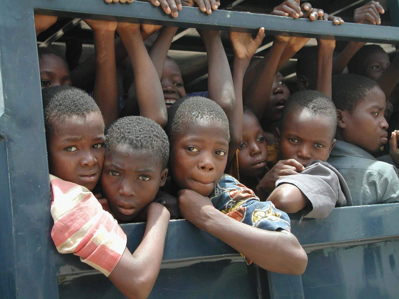 Dozens of slave children ride in the back of a police vehicle after they were apprehended at Seme Border, Nigeria. Much slavery in Nigeria and neighboring Benin involves the trafficking of women and children for sexual exploitation, domestic work or forced labor.