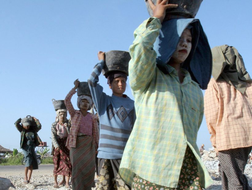 Myanmar construction workers carry baskets of stone during the construction of a road in Naypyidaw in 2006. Despite the UN's labor agency lifting restrictions against Myanmar this year over its failures to act on complaints of forced labor, around 380,000 people remain enslaved in the country, according to the Global Slavery Index.