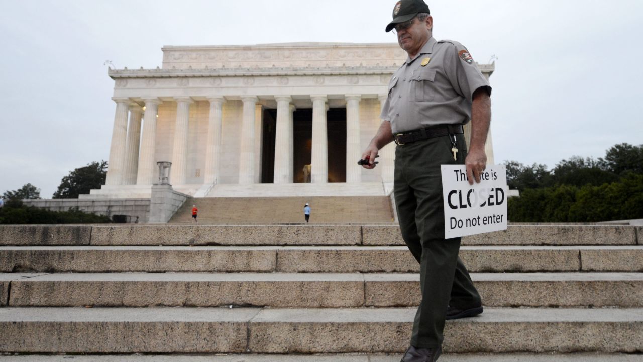 U.S. park ranger Richard Trott picks up closed signs at the Lincoln Memorial after it reopens October 17.