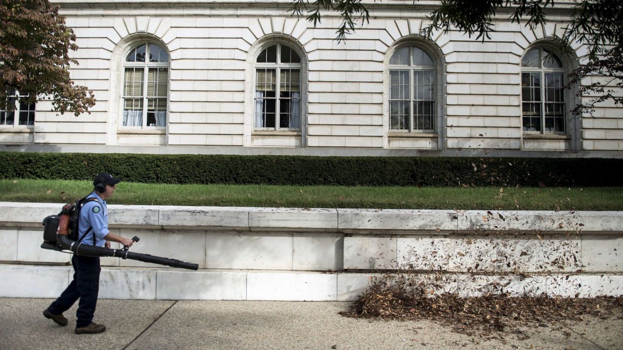 A worker blows leaves away from the Russell Senate Office Building in Washington on October 17.