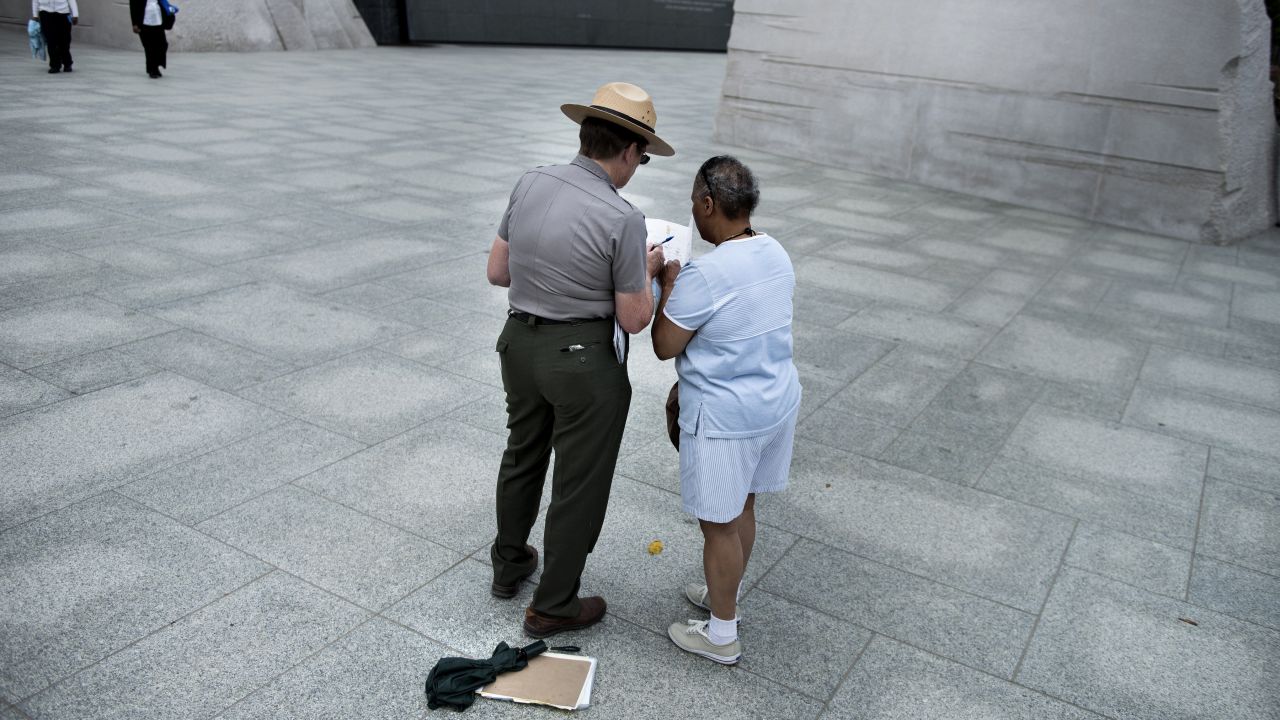 A U.S. park ranger helps a tourist at the Martin Luther King Jr. Memorial in Washington on October 17.