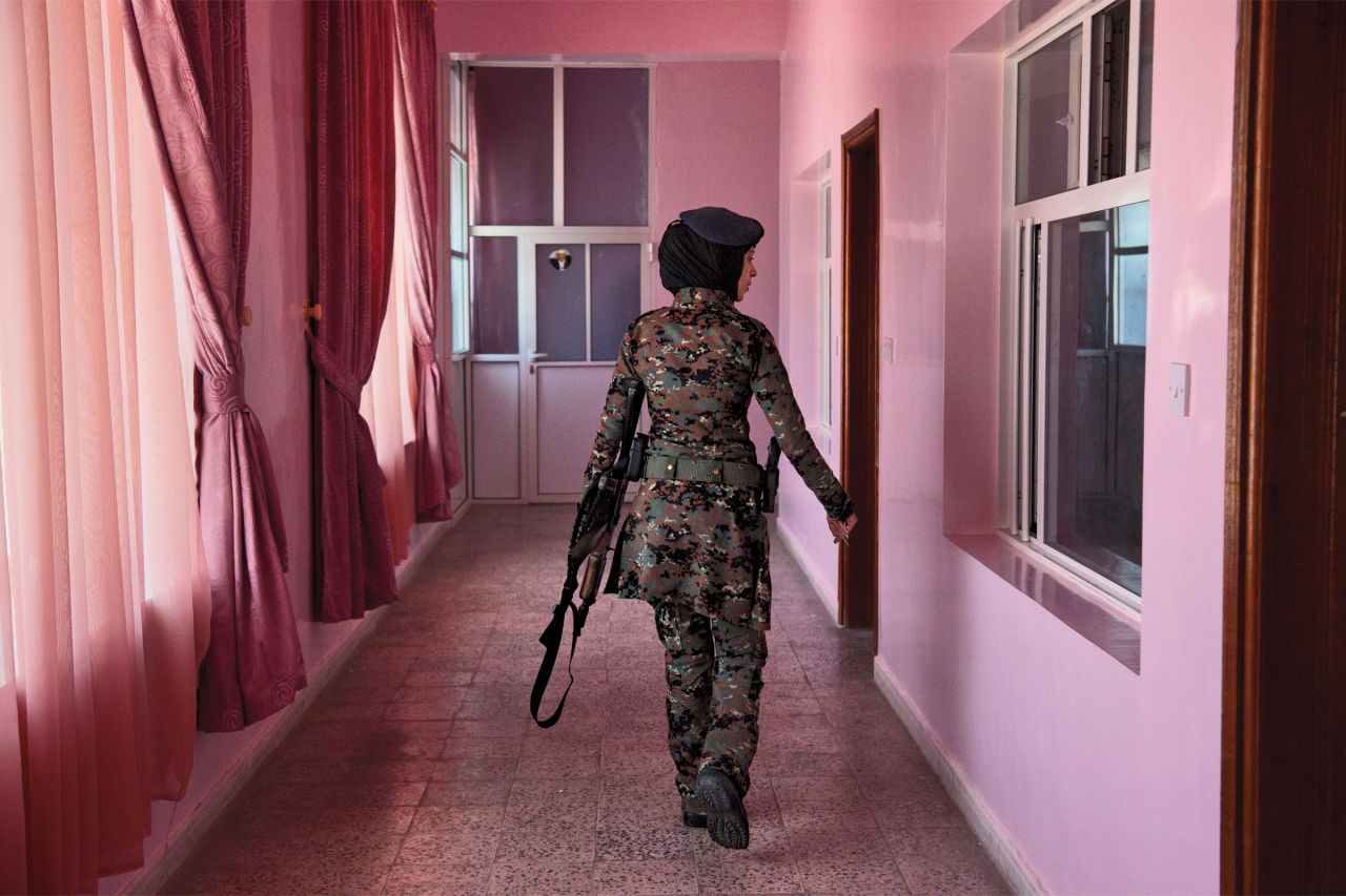 A female member of Yemen's elite counterterrorsim unit checks the barracks, in this photo from Stephanie Sinclair.