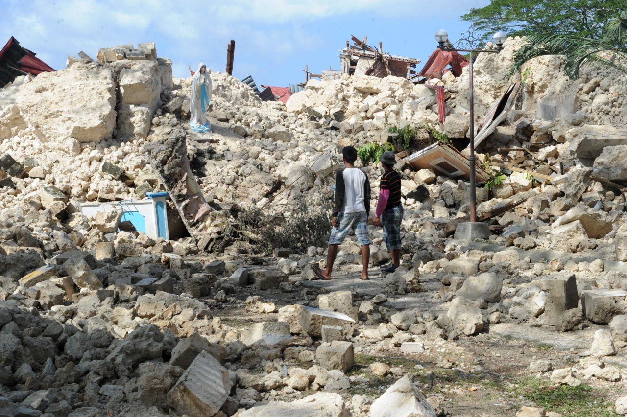 Residents view the ruins of the historic Holy Cross Parish Church in Maribojoc on the central Philippine island of Bohol on Friday, October 18. The death toll has risen above 180 after a magnitude-7.1 earthquake on October 15.
