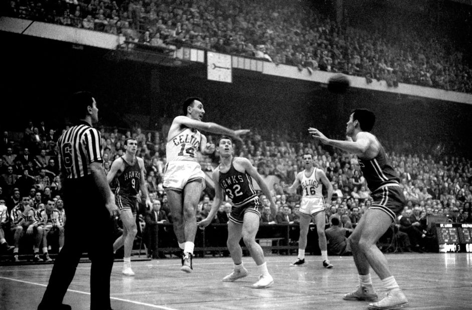 Boston Celtics great Bob Cousy makes a pass against the St. Louis Hawks in 1957. Cousy sold just about all the uniforms and memorabilia in his basement for around $320,000, which he gave to his two daughters, says Bob Greene.   