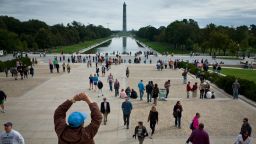A man stretches while walking down the steps of the Lincoln Memorial with the Washington Monument in the background on Saturday, October 19.