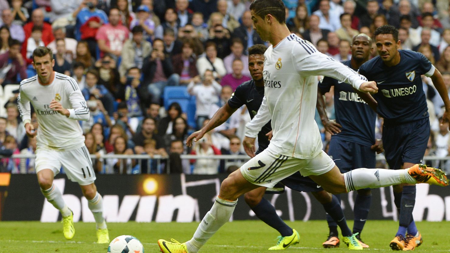 Gareth Bale (left) watches as Cristiano Ronaldo scores Real Madrid's second goal against Malaga from the penalty spot. 