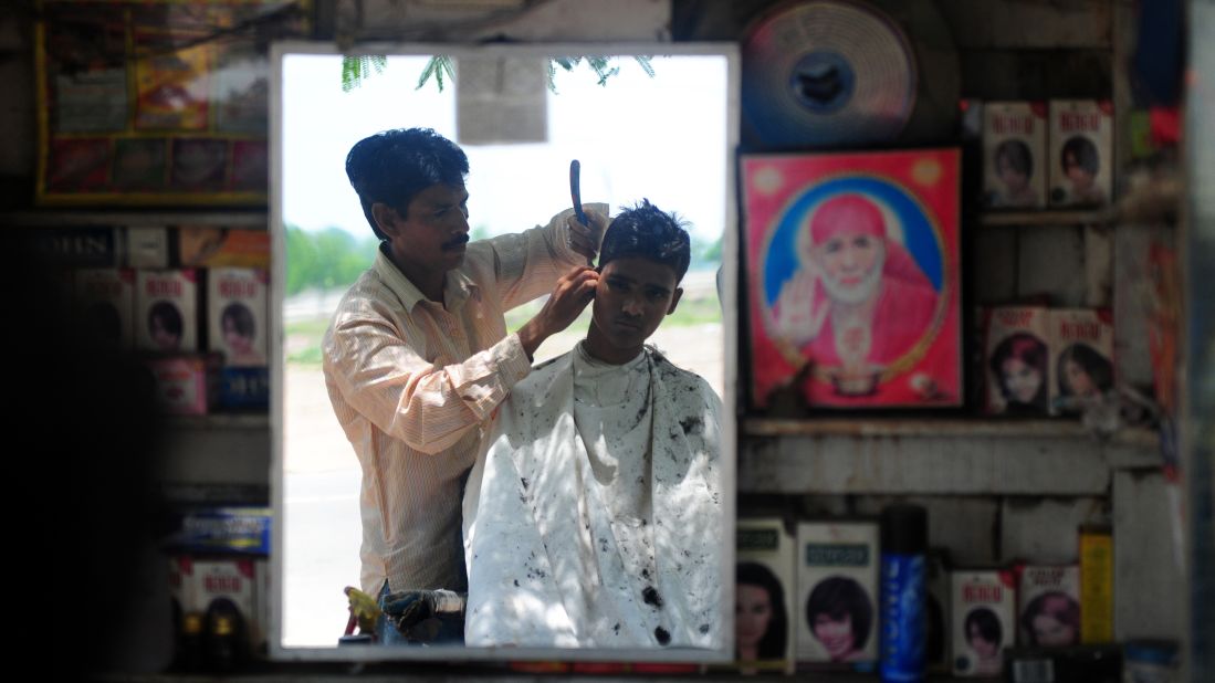 In India, it's not just the hair on your head that gets a snip. Barbers will take their scissors to wayward eyebrows, tufts of ear hair and nostrils. Then it's time to actually get started.