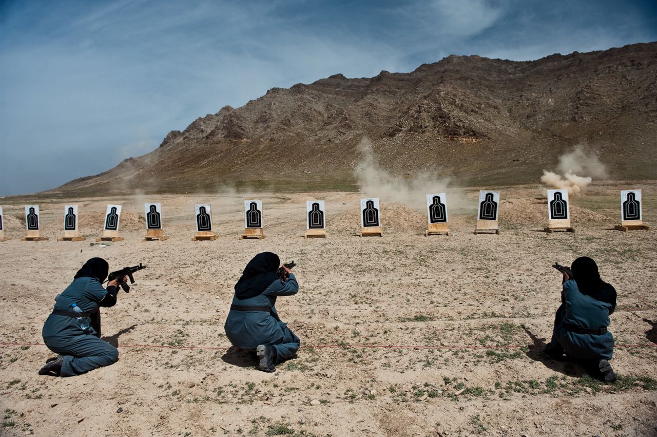 Women—mostly widows—train for police force jobs at a firing range near Kabul, in this image by Lynsey Addario. The female officers can take on tasks that men cannot because of Islamic custom: frisking other women, searching homes where female family members are present. 