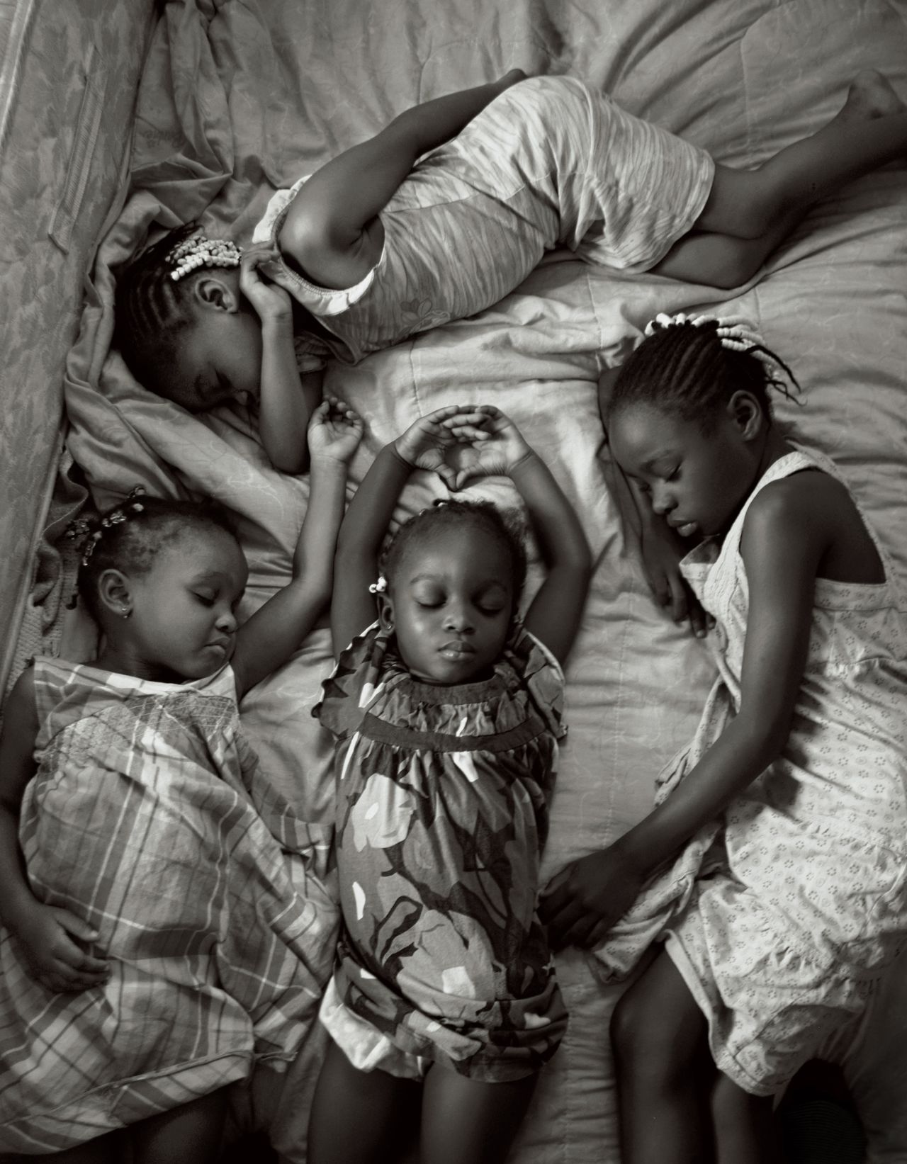 Photographer Maggie Steber took this photo of four young sisters in Miami, Florida, napping on a Sunday afternoon after attending church, as part of a feature on sleep. 