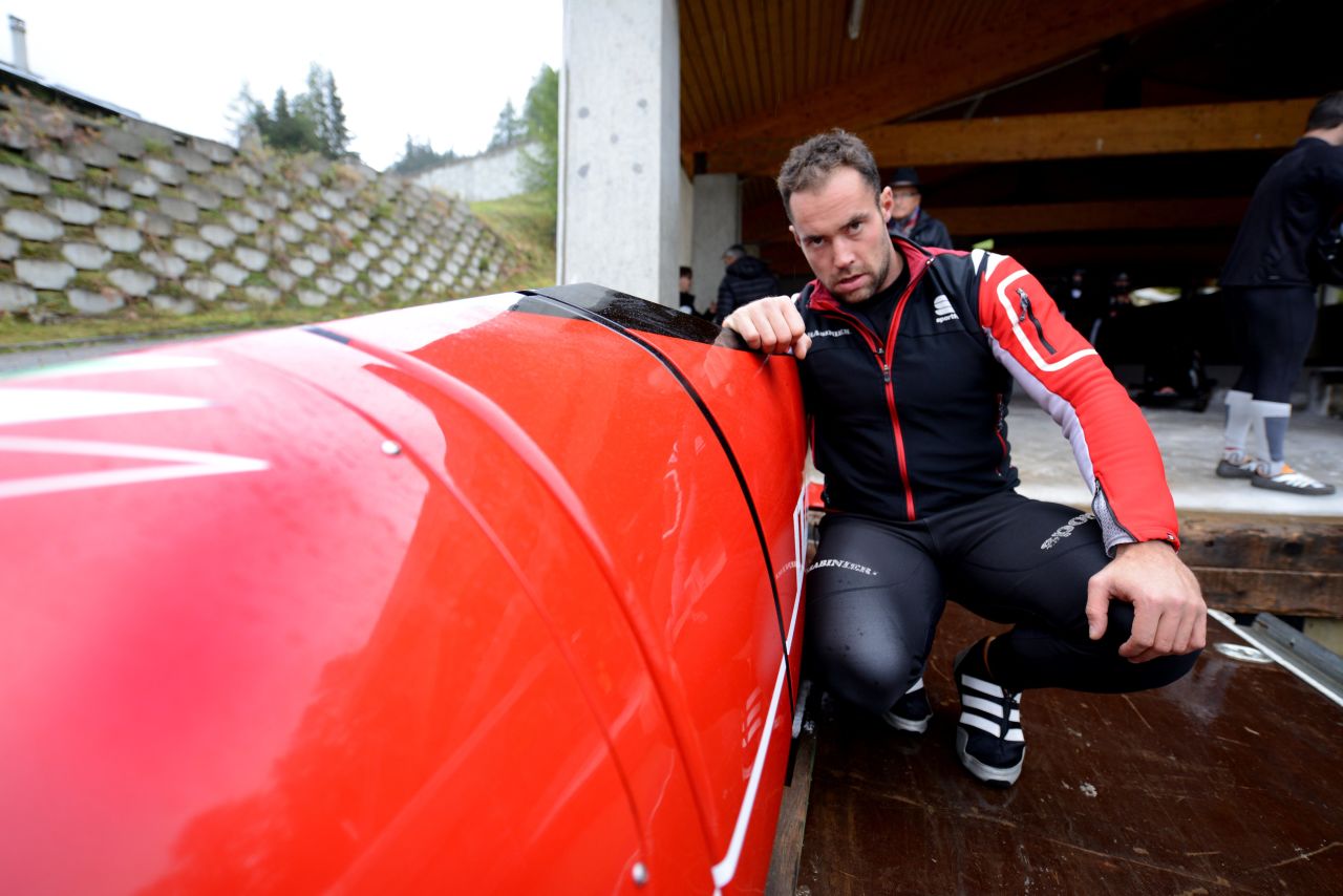 Italian bobsledder Simone Bertazzo inspects the sled he hopes will carry him and his teammates to gold at Sochi 2014. Its red livery is the hallmark of its designers, the legendary automotive manufacturer Ferrari.