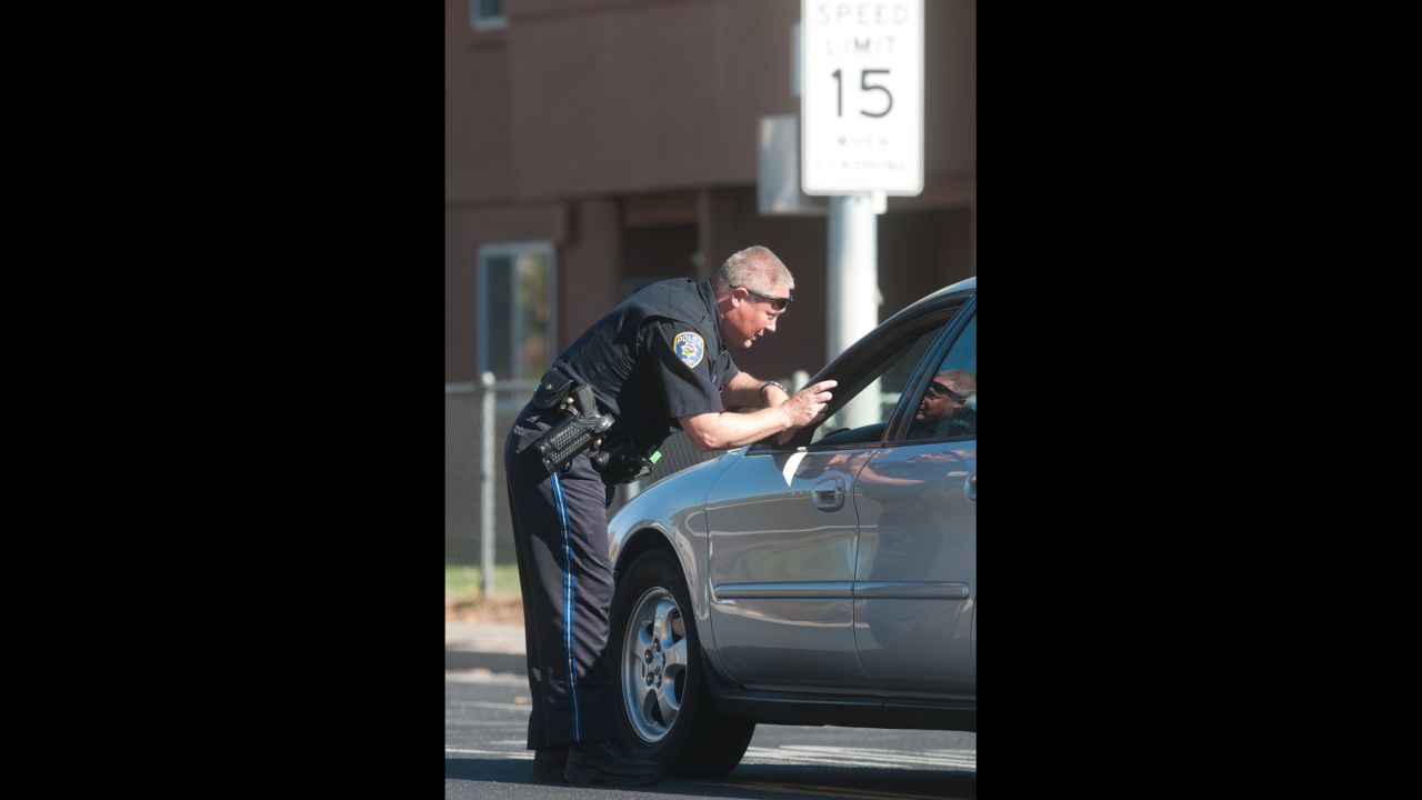 A police officer stops traffic near Agnes Risley Elementary.