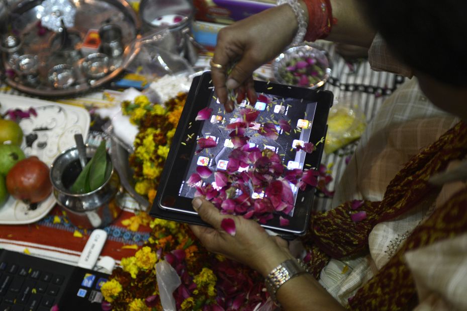 An Indian trader worships an iPad on Diwali, the Festival of Lights, in New Delhi on November 13, 2012. The worshipping of account books has long been an essential part of Diwali for the business community in India, and in a sign of the times some traders are now worshipping electronic gadgets as well. 