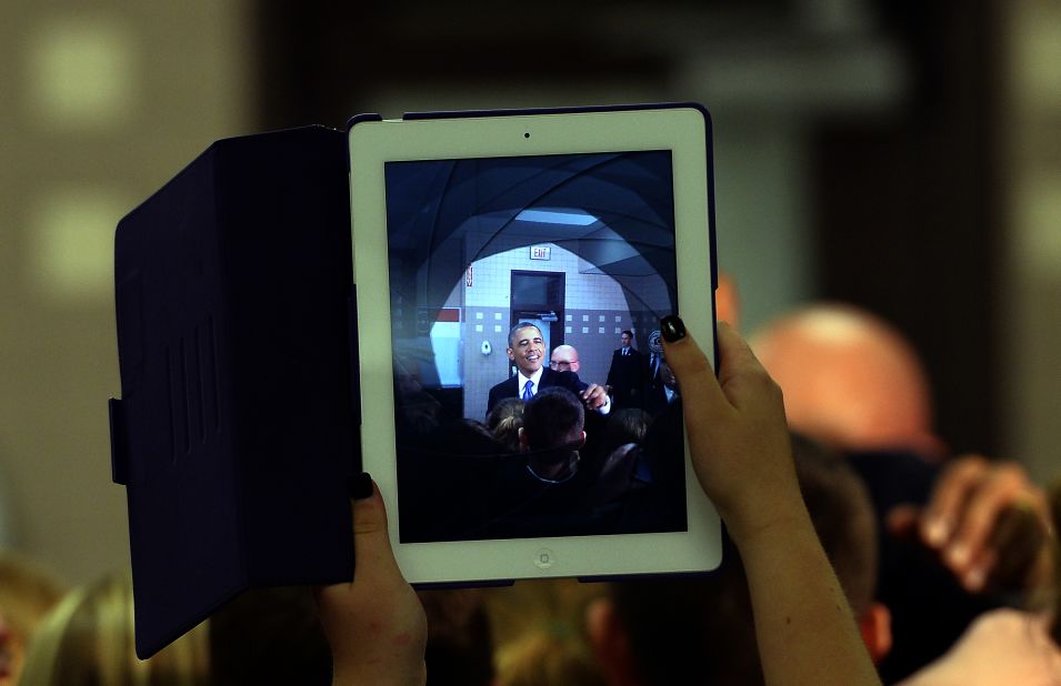 A student uses her iPad to take a picture of President Barack Obama as he greets students at a middle school in Mooresville, North Carolina, on June 6, 2013. 