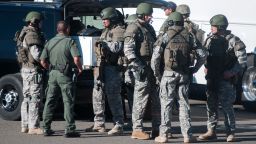 Swat team members secure the scene near Sparks Middle School in Sparks, Nev., after a shooting there on Monday, Oct. 21, 2013.  Authorities are reporting that two people were killed and two wounded at the Nevada middle school. (AP Photo/Kevin Clifford)