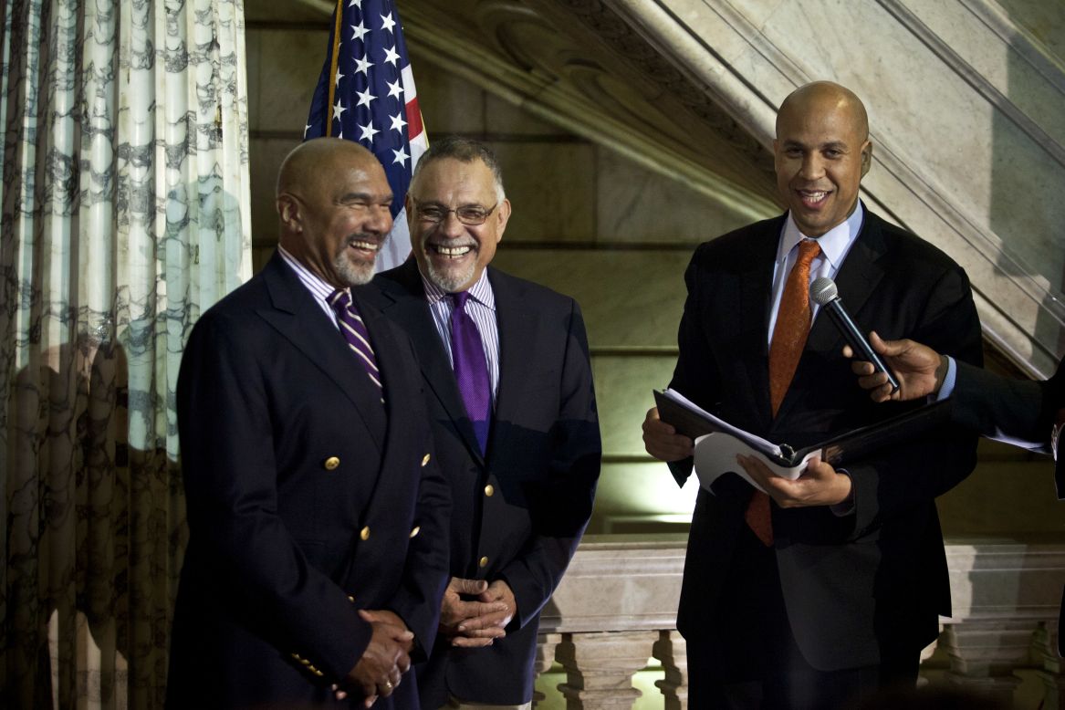 On October 21, 2013, Cory Booker, right, officiates a wedding ceremony for Joseph Panessidi, center, and Orville Bell at the Newark, New Jersey, City Hall. The New Jersey Supreme Court denied the state's request to prevent same-sex marriages temporarily, clearing the way for same-sex couples to marry.