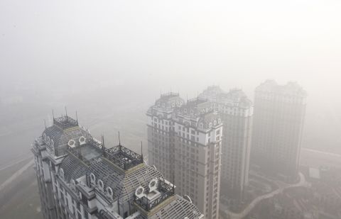 Harbin buildings are seen under heavy smog on October 22. Pollution levels there were far above international standards, the state-run China Daily reported.