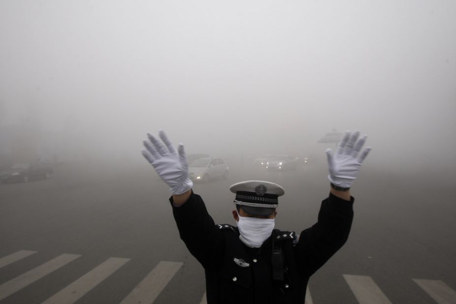 A policeman directs Harbin traffic on Monday, October 21. In some central areas of the city, visibility was less than 20 meters (65 feet). 