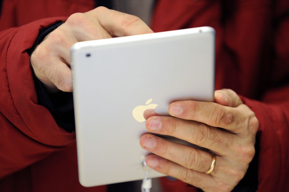 A man uses a iPad Mini, which was released by Apple on November 2, 2012. Here's a look back at the history of the iPad, the tablet computer that Apple first introduced in 2010.
