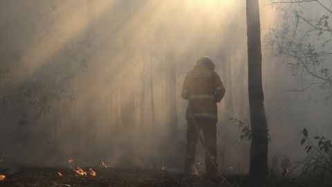 A firefighter mops up on October 23, after a firestorm swept through Bilpin.