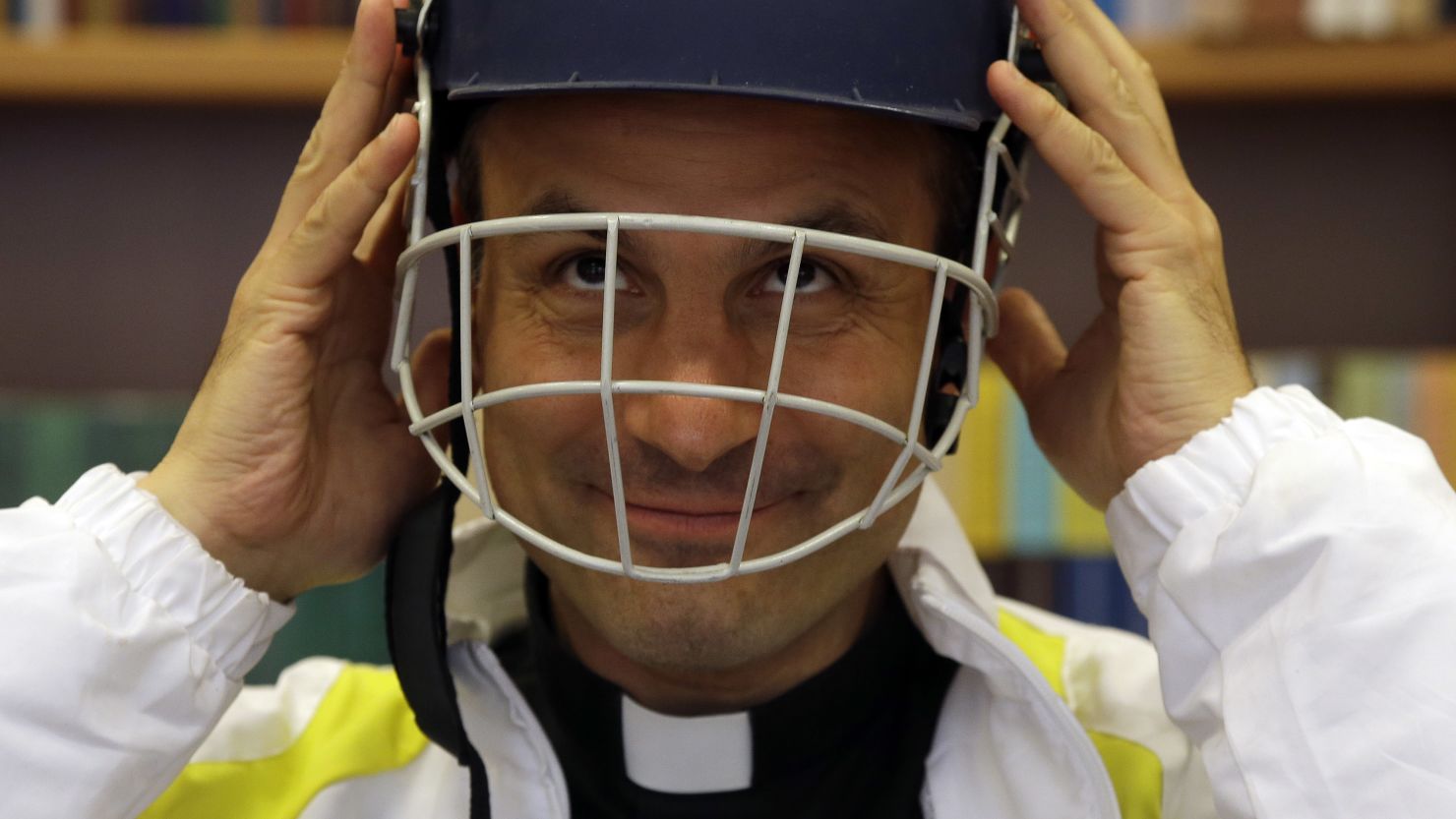 Monsignor Sanchez de Toca y Alameda wears a helmet during the presentation of the Vatican cricket club on October 22.