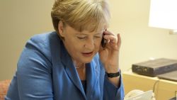 German Chancellor Angela Merkel speaks on a mobile phone on October 23, 2011 in Brussels, Belgium.