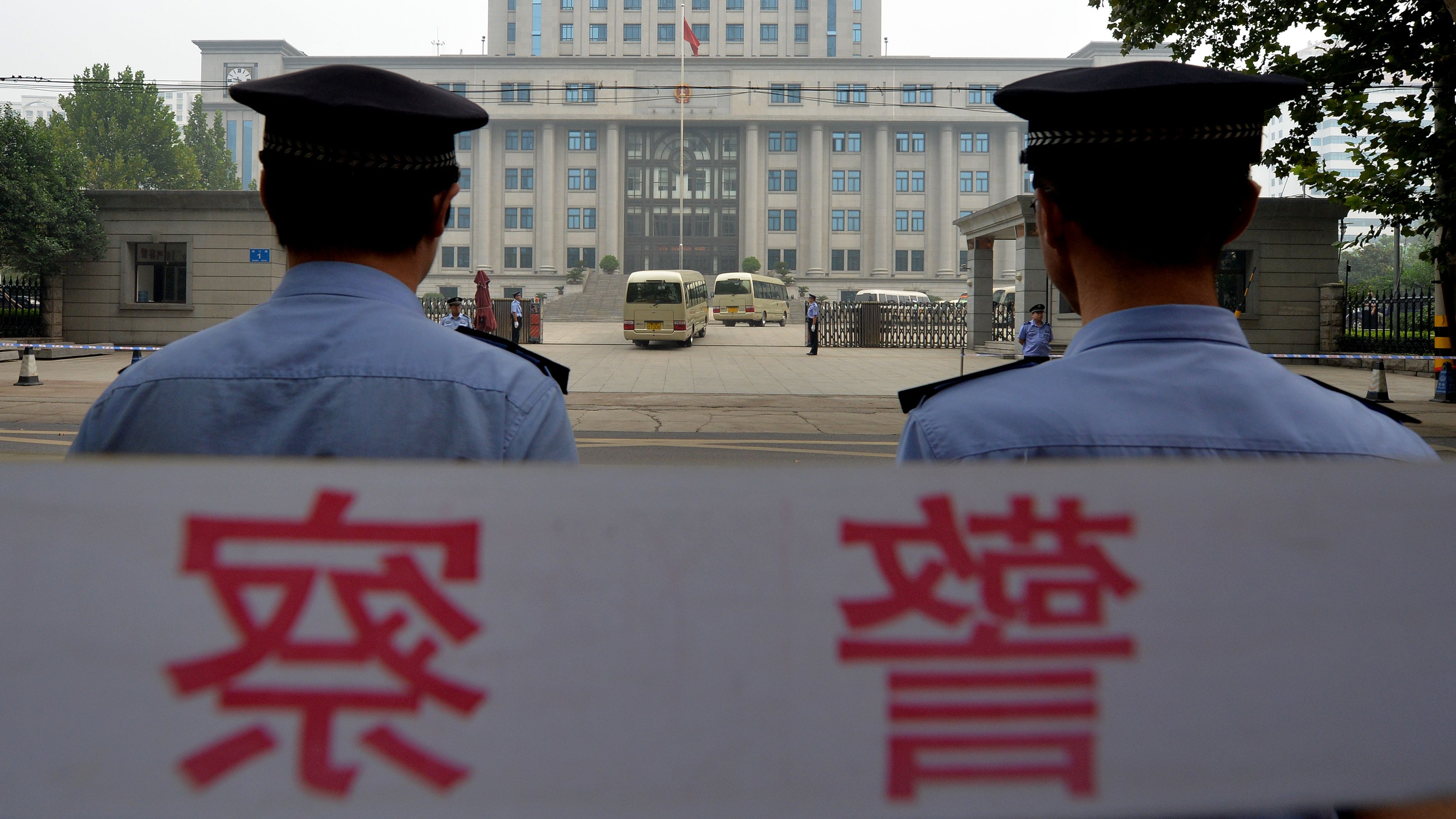Police stand guard outside the court where disgraced politician Bo Xilai was sentenced to life in prison in September.